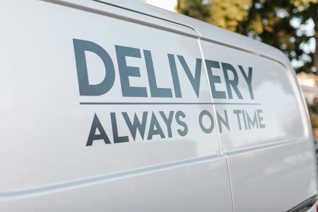 Kariera Close-up of delivery van with slogan 'Always On Time' emphasizing timely service.